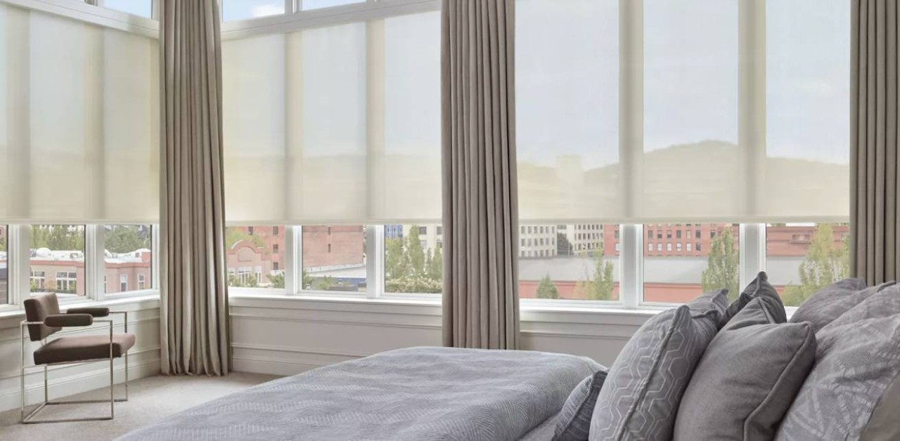 Solar shades paired with custom drapery in a modern bedroom at Covered Creations near Dallas, TX